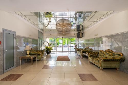 a lobby with couches and a glass ceiling at #1 Luxury Jacuzzi Penthouse In Quiet Centre Riga in Rīga