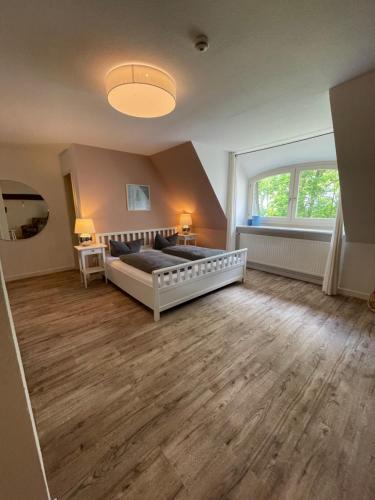 a bedroom with a bed and a large window at Hotel Gut Schöneworth in Freiburg - Elbe