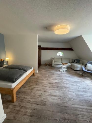 a bedroom with a bed and a living room at Hotel Gut Schöneworth in Freiburg - Elbe