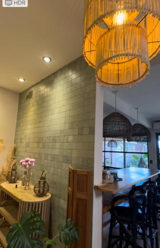 a dining room with a table and some chandeliers at Tanah Host - Casa de Huespedes in Villa Mercedes