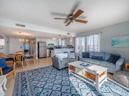 a living room with a couch and a table at Sunskipper #6G - At Ease in Carolina Beach