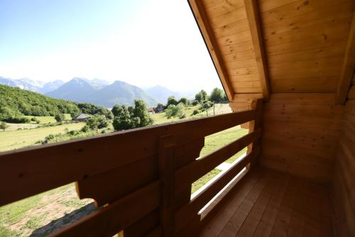a room with a balcony with a view of mountains at Soulrest EkoResort - Mehov Konak in Gusinje