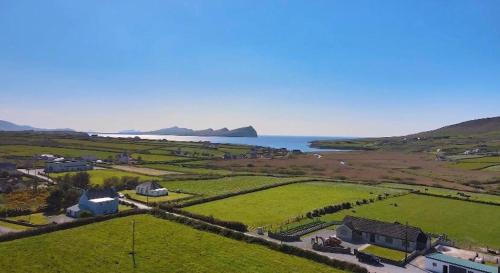 an aerial view of a farm and the ocean at An Riasc Farmhouse Rental in Dingle