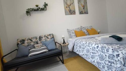 a bedroom with a bed and a bench at Appart confort Paris Cergy gare in Cergy