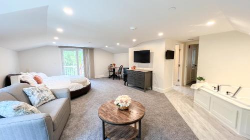 a large living room with a bed and a couch at Four Seasons For Fun Bed & Breakfast in Lakeville