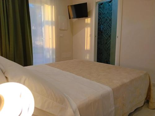 a bedroom with a white bed and a window at Pietra Di Puglia in Monopoli