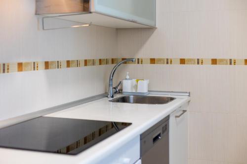 a kitchen with a sink and a counter top at Piso A Pie de Playa - A Corna in San Pedro
