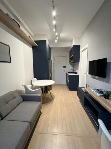 a living room with a couch and a table at Innvista Nex One Itaim in Sao Paulo