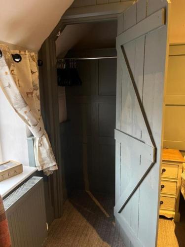 a closet with a door in a room at The Crown Inn in Gayton