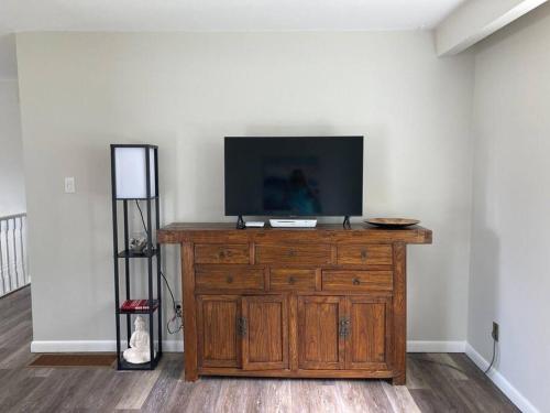 a television on top of a wooden dresser in a room at Direct Lakefront cottage on Lake Simcoe in Orillia in Orillia