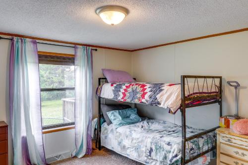 a bedroom with two bunk beds and a window at Kadoka Home about 22 Mi to Badlands National Park! in Kadoka