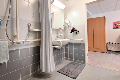 a bathroom with a sink and a shower at Gästehaus St. Martin in Ulmen