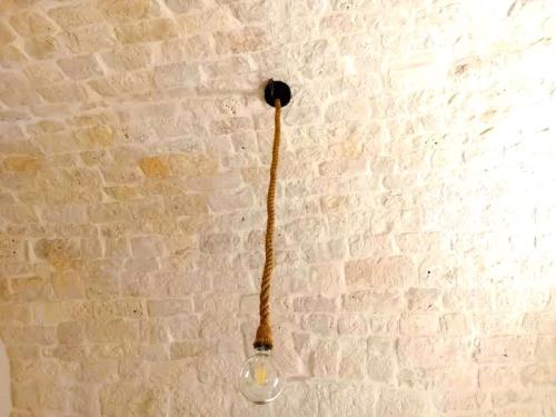 a glass vase with a stem on a wall at Pietra Di Puglia in Monopoli