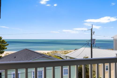 a view of the ocean from a balcony at Tropical Winds - Ferda Buoys in Carolina Beach