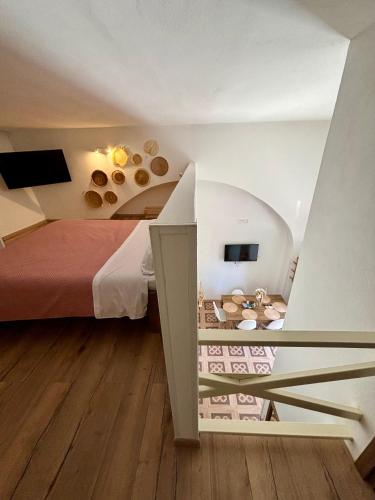 a attic bedroom with a bed and a room with at PortaLecce B&B in Brindisi