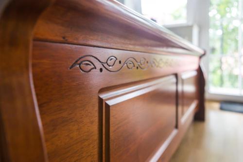 a wooden cabinet with a writing on it at Villa Jeziorki 71 in Warsaw