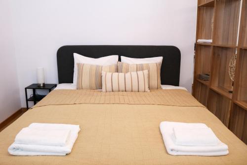 a bedroom with a bed with two towels on it at Cluj Downtown Accomodation in Cluj-Napoca