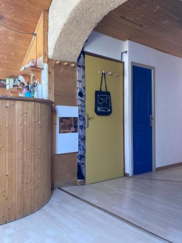 a room with a door and a purse on a wall at flat-sharing Colocation in Briançon