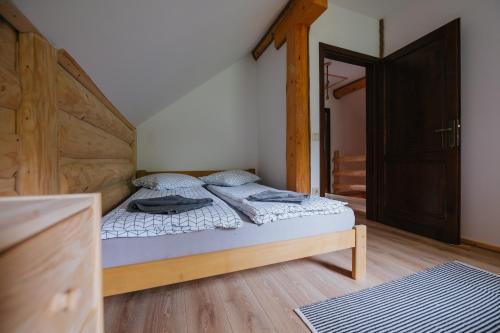 a bedroom with a bed with a wooden headboard at Log Cabin Piricske in Ciceu