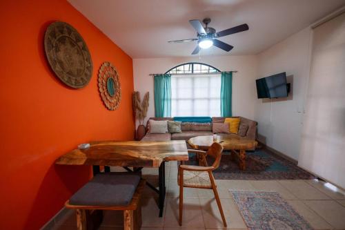 a living room with a table and a couch at Villa Cascada By Vacation Pura Vida in Esterillos Este