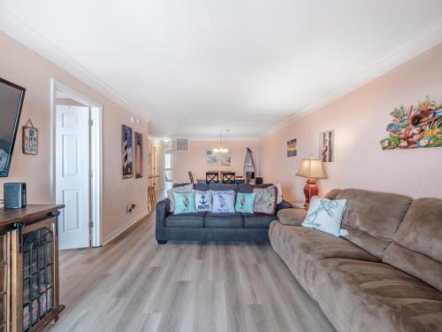 a living room with a couch and a tv at Winds V1 #2B - My Paradise in Carolina Beach
