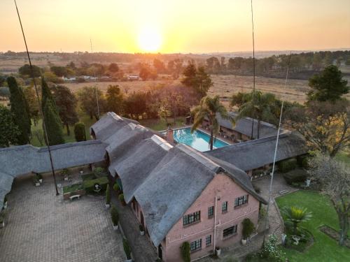an aerial view of a house with a pool at Owls Loft Guest House in Midrand