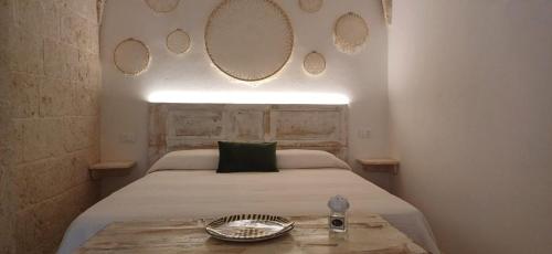a bedroom with a bed with mirrors on the wall at Casamareluna in Ostuni
