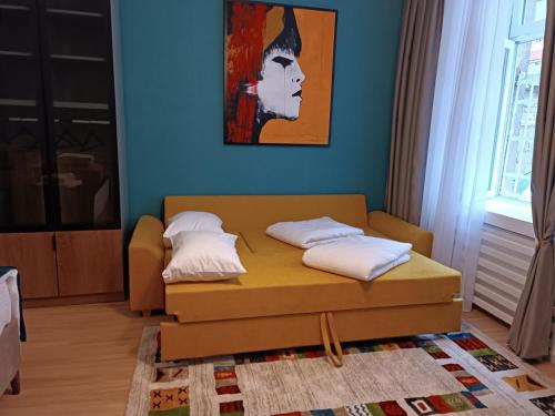 a room with a bed and a painting on the wall at Apartman Verde free parking in Sarajevo