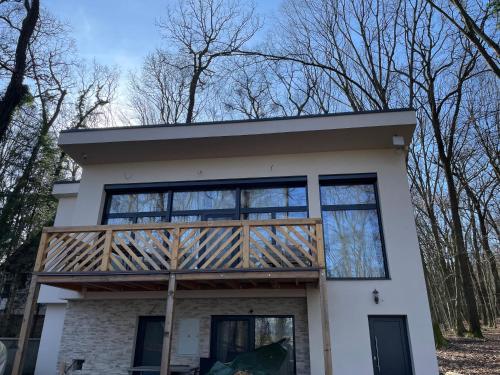 a house with a deck on top of it at Apartmány Ľadovo in Lučenec