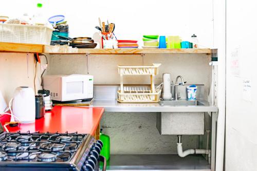a kitchen with a sink and a stove top oven at HOM Centro histórico in Mexico City