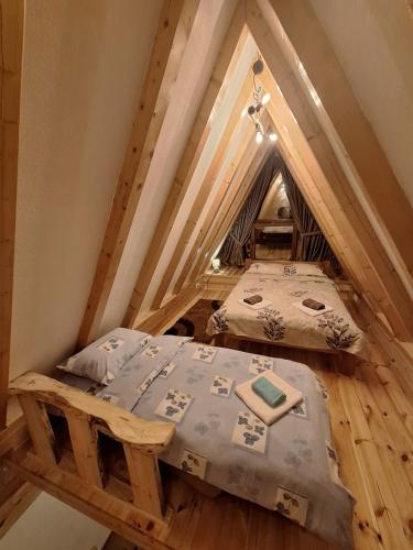 a bedroom with two beds in a attic at Bungalow Kalina in Žabljak