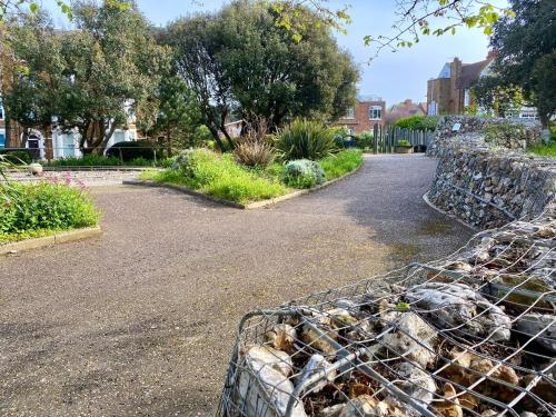 a fence in the middle of a garden at Beach Apartment, Hunstanton Norfolk in Hunstanton