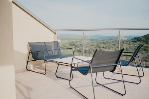 two chairs and a table on a balcony at Lavender residence Villa Drage with pool and wellness in Drage
