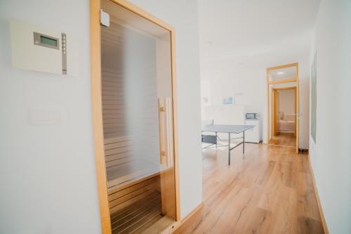 a hallway with a door leading into a room with a table at Lavender residence Villa Drage with pool and wellness in Drage
