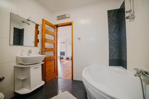 a bathroom with a sink and a tub and a toilet at Lavender residence Villa Drage with pool and wellness in Drage
