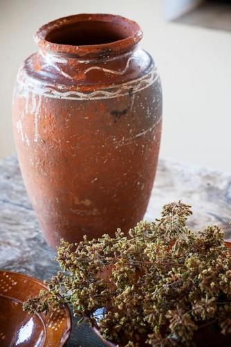 a brown vase sitting on a table with a plant at Villa Vouno - luxury and privacy in the Aegean in Klíma