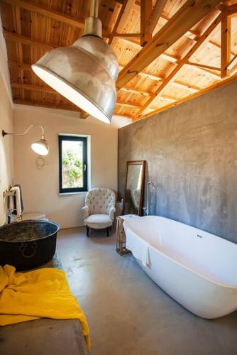 a large bathroom with a large tub and a sink at Villa Vouno - luxury and privacy in the Aegean in Klíma
