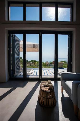 a living room with a couch and a table at Villa Vouno - luxury and privacy in the Aegean in Klíma