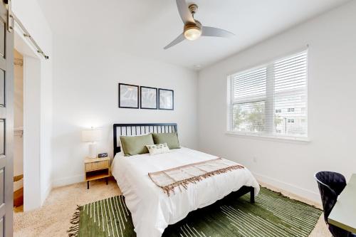 a white bedroom with a bed and a window at 2 Mi to UF Campus! Dog-Friendly Condo w/ Pool in West Hills