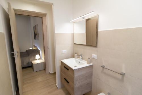 a bathroom with a sink and a mirror at Veranda sul Verde in Ficarazzi