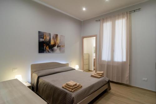 a bedroom with a bed with two towels on it at Veranda sul Verde in Ficarazzi