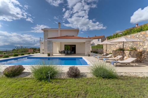 a villa with a swimming pool and a house at Villa Mihojka in Malinska