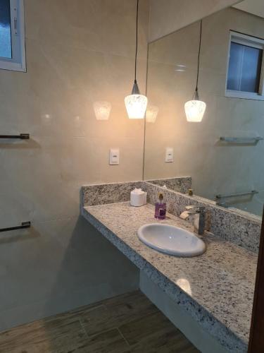 a bathroom with a sink and a mirror at VIA SPE - Pousada in Belo Horizonte
