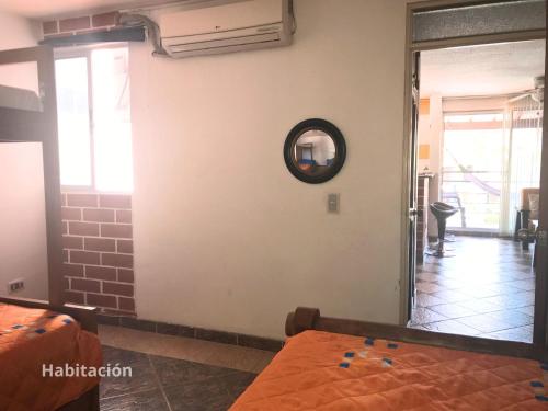 a room with a mirror on the wall at """Apartamento 2 Habit en Ciudadela del Sol -Condominio, 4 piscinas, a una cuadra del parque""" in San Jerónimo