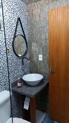 a bathroom with a sink and a mirror on a counter at Casa Nas Montanhas Capixabas in Domingos Martins