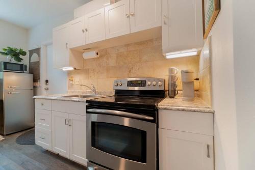 a kitchen with a stove top oven next to a sink at Garden Oasis in Flamingo Park in West Palm Beach
