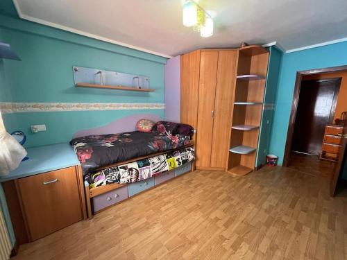 a small bedroom with a bed and a book shelf at Peris in Gijón