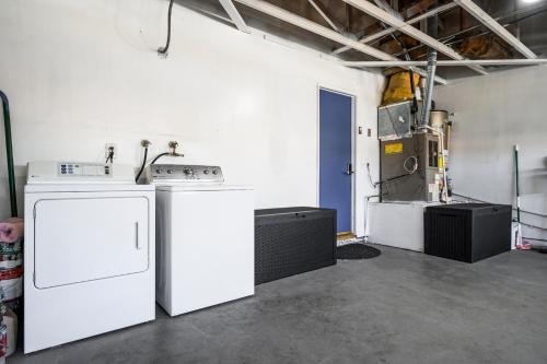 a kitchen with white appliances in a room at Mins to Disney Chic 3BR with Arcade in Santa Ana