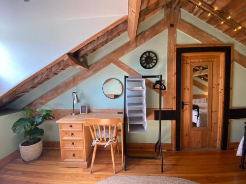 a room with a desk and a ladder next to a desk at The Old Granary in Norwich
