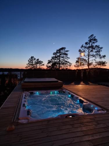a hot tub sitting on top of a wooden deck at Privat Spirit Spa Villa in Vallentuna